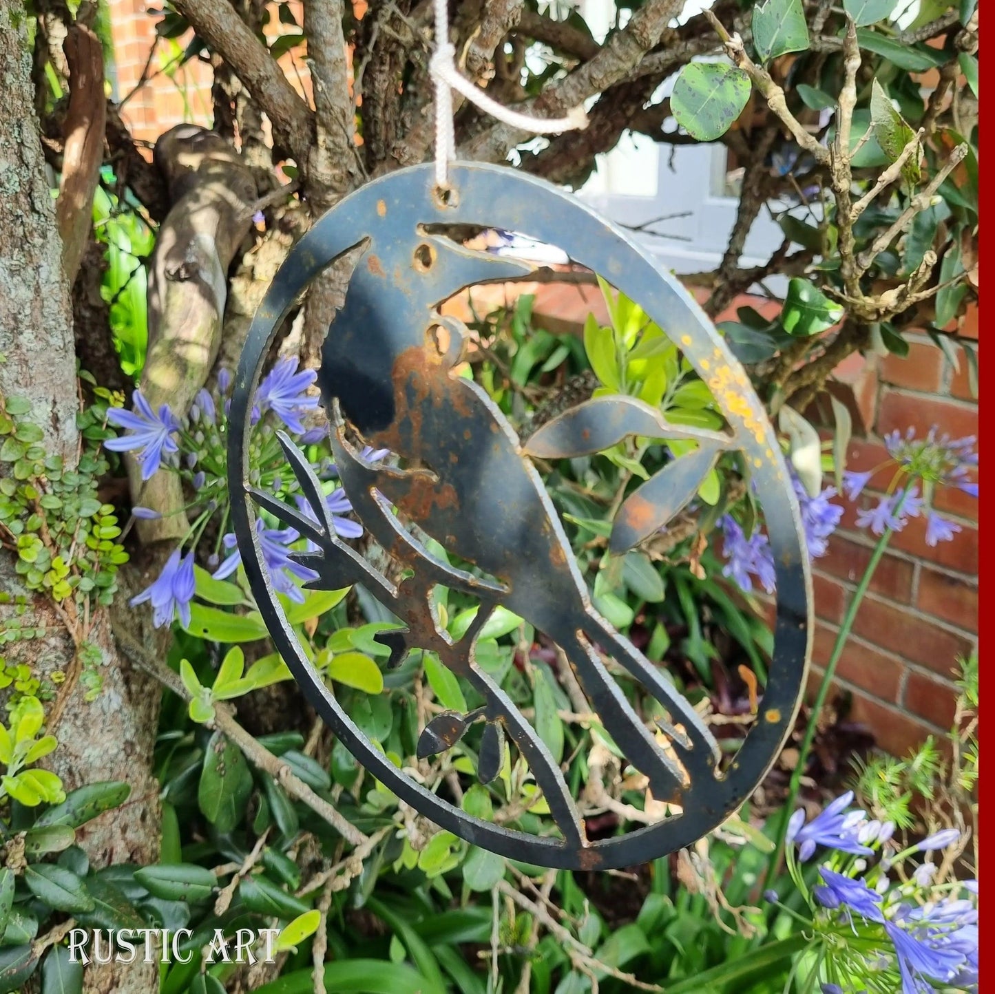 hanging Rusty Metal Bird TUI in circle approx 160mm in dia - Vintique Concepts