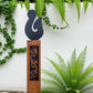 Black metal NZ Hei Matau (Fish Hook) on Rustic Oak Post-Garden Art-Vintique Concepts